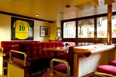 a restaurant with a red couch and a table at Madison Manor Boutique Hotel in Toronto