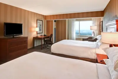 a hotel room with two beds and a flat screen tv at DoubleTree Fallsview Resort & Spa by Hilton - Niagara Falls in Niagara Falls