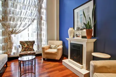 a living room with a fireplace and chairs at DoubleTree Fallsview Resort & Spa by Hilton - Niagara Falls in Niagara Falls