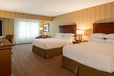 a hotel room with two beds and a flat screen tv at DoubleTree Fallsview Resort & Spa by Hilton - Niagara Falls in Niagara Falls