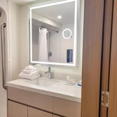 a white bathroom with a sink and a mirror at Living Stone Golf Resort in Collingwood