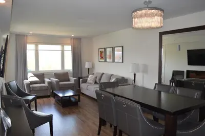 a living room with a couch and a table and chairs at Living Stone Golf Resort in Collingwood