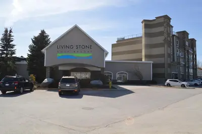 a parking lot with cars parked in front of a building at Living Stone Golf Resort in Collingwood