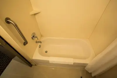 a bath tub in a bathroom with a shower at The Village Inn in Elora