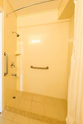 a bathroom with a shower with a shower curtain at The Village Inn in Elora