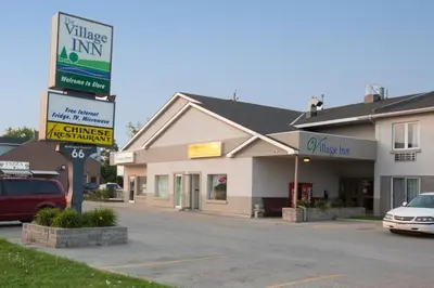 a building with a sign in front of it at The Village Inn in Elora