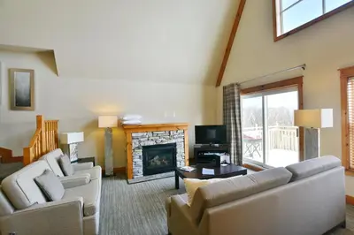 a living room with two couches and a fireplace at The Blue Escape Blue Mountain Chalet in Blue Mountains