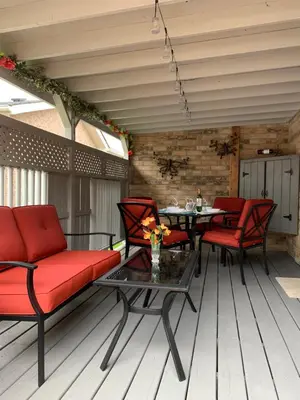 a patio with red furniture and a table and chairs at Evening Shade in Fergus
