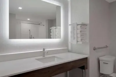 a white bathroom with a sink and a mirror at Hampton Inn by Hilton Brampton - Toronto in Brampton