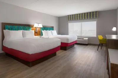 a hotel room with two beds and a window at Hampton Inn by Hilton Brampton - Toronto in Brampton