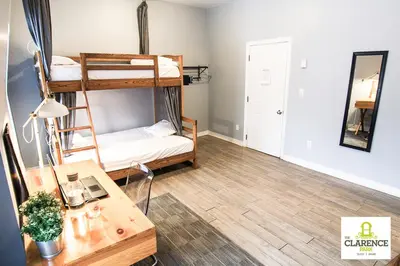 a room with two bunk beds and a desk at The Clarence Park in Toronto
