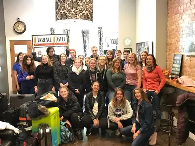 a group of people posing for a picture in a room at The Clarence Park in Toronto