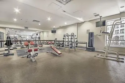 a gym with a lot of equipment in a building at Mississauga Furnished Apartments in Mississauga