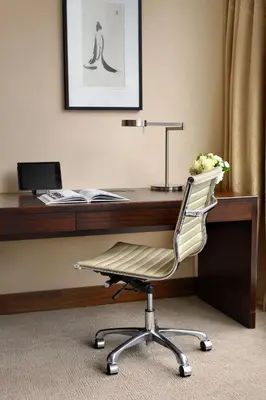 a office with a desk with a chair and a computer at Shangri-La Toronto in Toronto