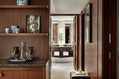 a hallway leading to a bathroom with a sink at Shangri-La Toronto in Toronto