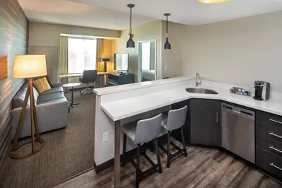 a kitchen with a sink and a living room at Residence Inn by Marriott Toronto Mississauga West in Mississauga