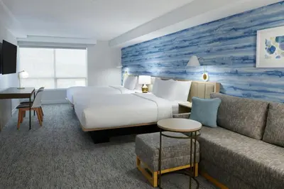 a hotel room with a bed and a couch at TownePlace Suites by Marriott Niagara Falls Canada in Niagara Falls