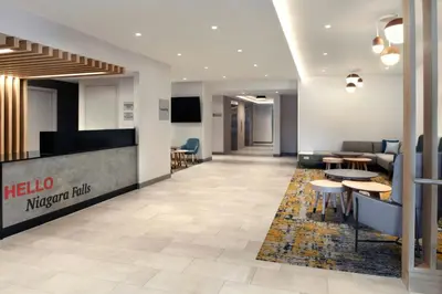 a lobby of a hotel with tables and chairs at TownePlace Suites by Marriott Niagara Falls Canada in Niagara Falls