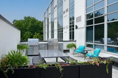 a patio with a table and chairs and a building at TownePlace Suites by Marriott Niagara Falls Canada in Niagara Falls