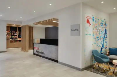 a lobby with a sign on a wall and a desk at TownePlace Suites by Marriott Niagara Falls Canada in Niagara Falls