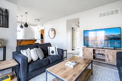 a living room with a couch and a large screen tv at Beautiful & Bright 3 Bed Townhome Near Village in Blue Mountains