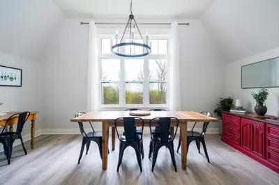 a dining room with a wooden table and black chairs at Beautiful & Bright 3 Bed Townhome Near Village in Blue Mountains