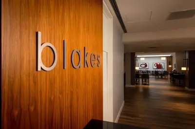 a wooden wall with the word oles on it at Doubletree by Hilton London in London