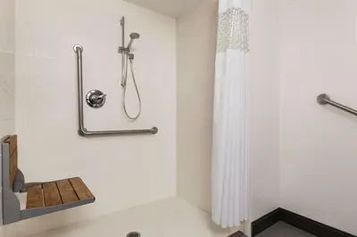 a shower stall with a shower curtain in a bathroom at Hampton Inn London Ontario in London