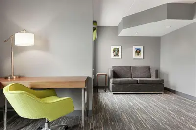 a living room with a desk and a couch at Hampton Inn London Ontario in London