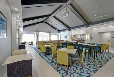a dining room with tables and chairs at Homewood Suites by Hilton London Ontario in London