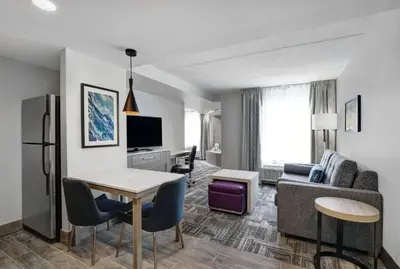 a living room with a couch and a table at Homewood Suites by Hilton London Ontario in London