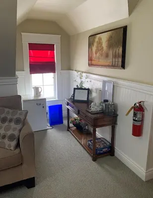 a living room with a table and a couch at The Red Coat in Niagara on the Lake