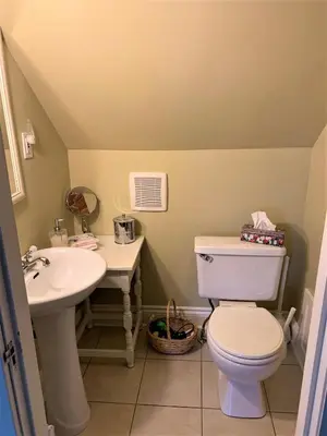 a bathroom with a toilet and a sink at The Red Coat in Niagara on the Lake