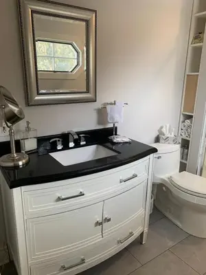 a bathroom with a white sink and a toilet at The Red Coat in Niagara on the Lake