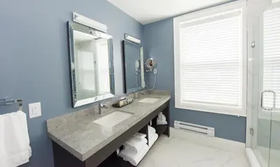 a bathroom with two sinks and a large mirror at 124 on Queen Hotel & Spa in Niagara on the Lake