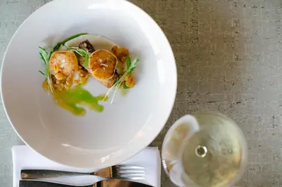 a white bowl with food in it on a table at 124 on Queen Hotel & Spa in Niagara on the Lake