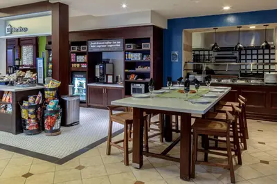 a restaurant with a table and chairs in a store at Hilton Garden Inn Niagara-on-the-Lake in Niagara on the Lake