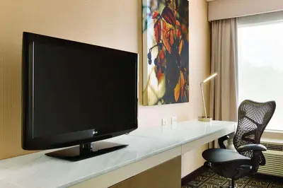 a flat screen tv sitting on a desk in a room at Hilton Garden Inn Niagara-on-the-Lake in Niagara on the Lake