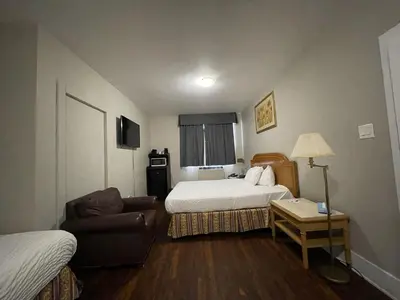 a hotel room with a bed and a couch at London Residency Inn in London