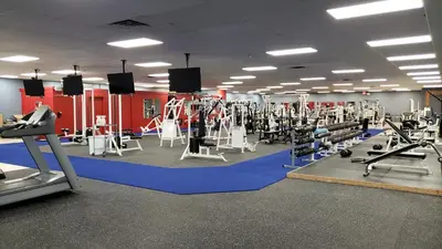 a gym with tread machines and people in it at Travelodge by Wyndham Simcoe in Simcoe