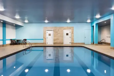 a swimming pool in a building with blue walls at Travelodge by Wyndham Simcoe in Simcoe