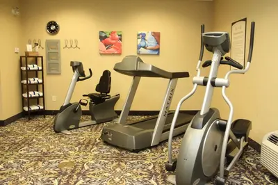 a gym with two exercise bikes in a room at Staybridge Suites London by IHG in London