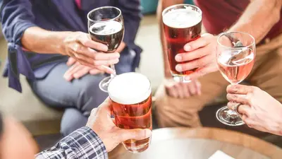 a group of people holding glasses of beer at Staybridge Suites London by IHG in London
