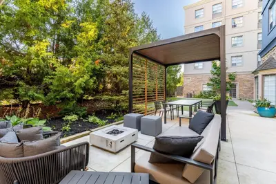 a patio with a gazebo with a table and chairs at Staybridge Suites London by IHG in London