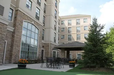 a group of tables and chairs in front of a building at Staybridge Suites London by IHG in London