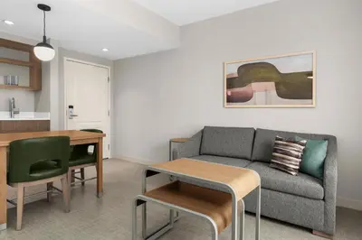 a living room with a couch and a table at Homewood Suites by Hilton Burlington in Burlington