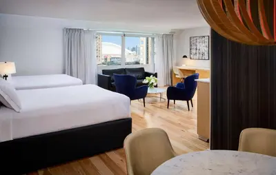 a hotel room with a bed and a living room at Radisson Blu Toronto Downtown in Toronto