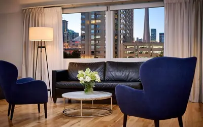 a living room with a couch and two chairs and a table at Radisson Blu Toronto Downtown in Toronto