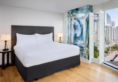 a bedroom with a large bed and a large window at Radisson Blu Toronto Downtown in Toronto