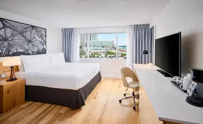 a hotel room with a bed and a desk with a computer at Radisson Blu Toronto Downtown in Toronto